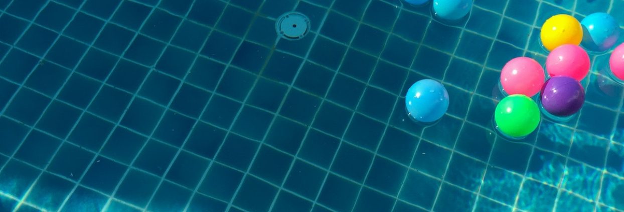 Assorted-color Balls Floating on Water